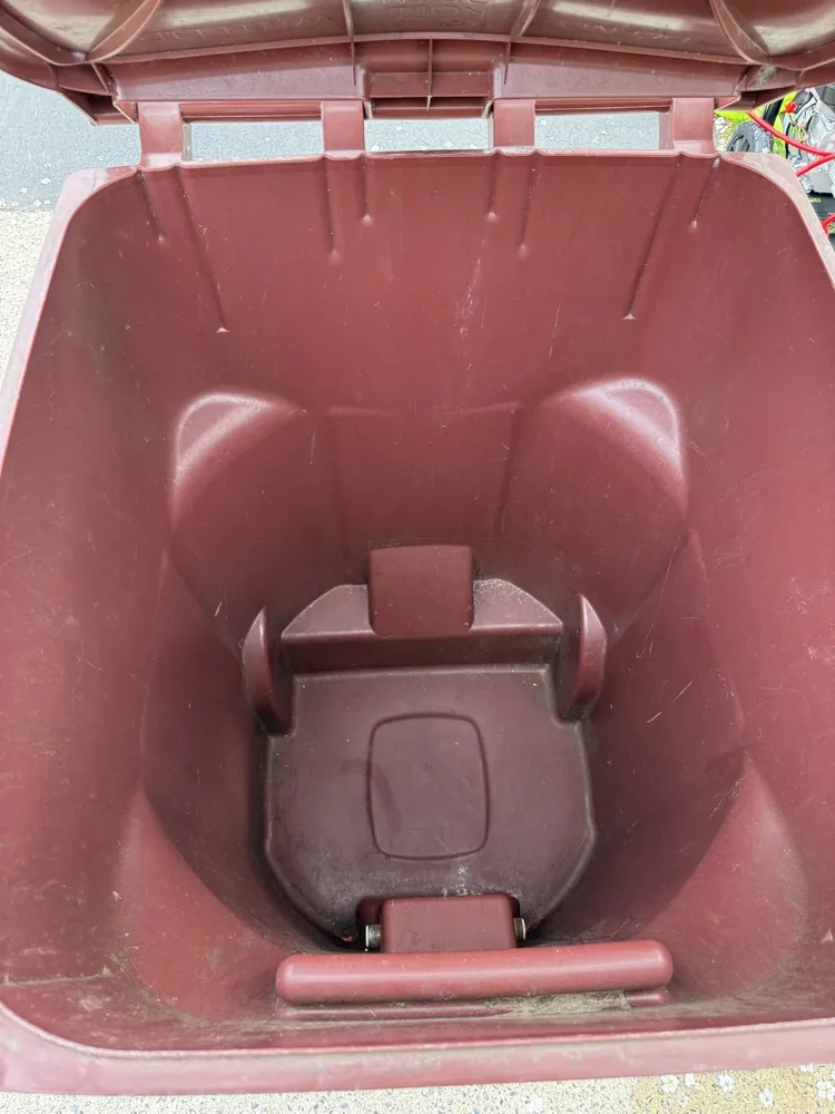 Dirty trash can interior caked with grime before cleaning