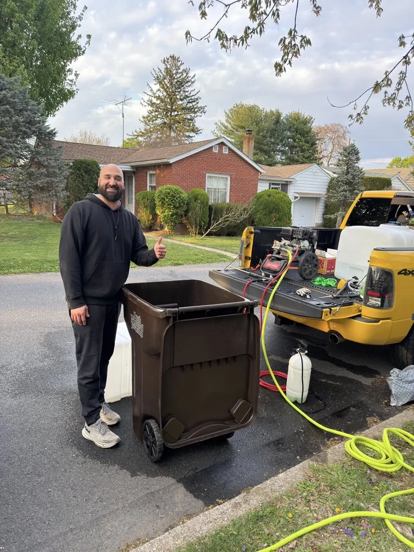Shane Lane, owner of Bin Busters, with his truck and a freshly cleaned trash can in the Lehigh Valley